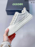 Side profile of the white low-top sneaker showing its layered panels, lace-up construction and raised sole.