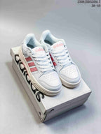 White and pink adidas Entrap sneakers displayed on an adidas shoebox, showing the front and side panels.