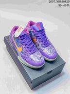 Pair of purple Nike Kobe 4 Protro basketball shoes displayed on a shoebox, showing the multicolor upper, yellow-orange Swoosh details and purple laces.