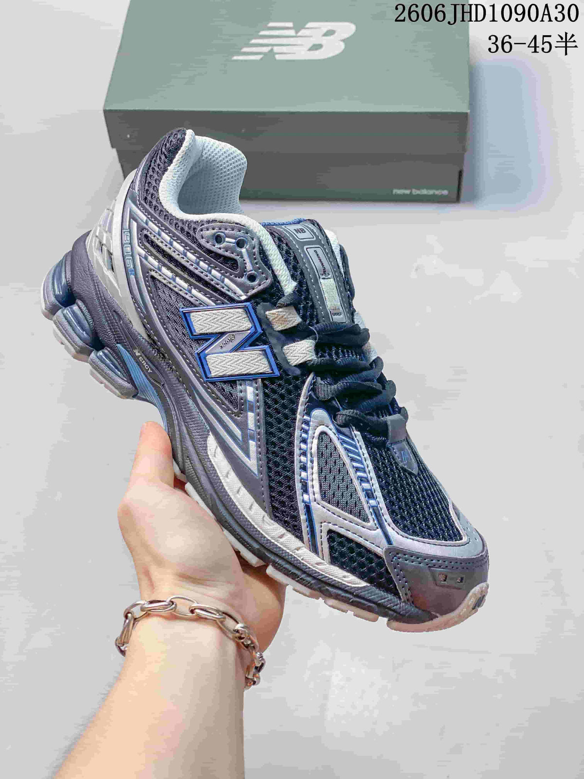 Dark mesh New Balance M1906R sneaker with silver and blue details
