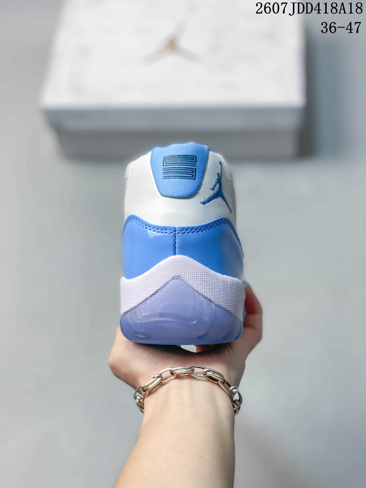 Rear view showing the Jordan logo, blue heel panel, white collar and translucent outsole.