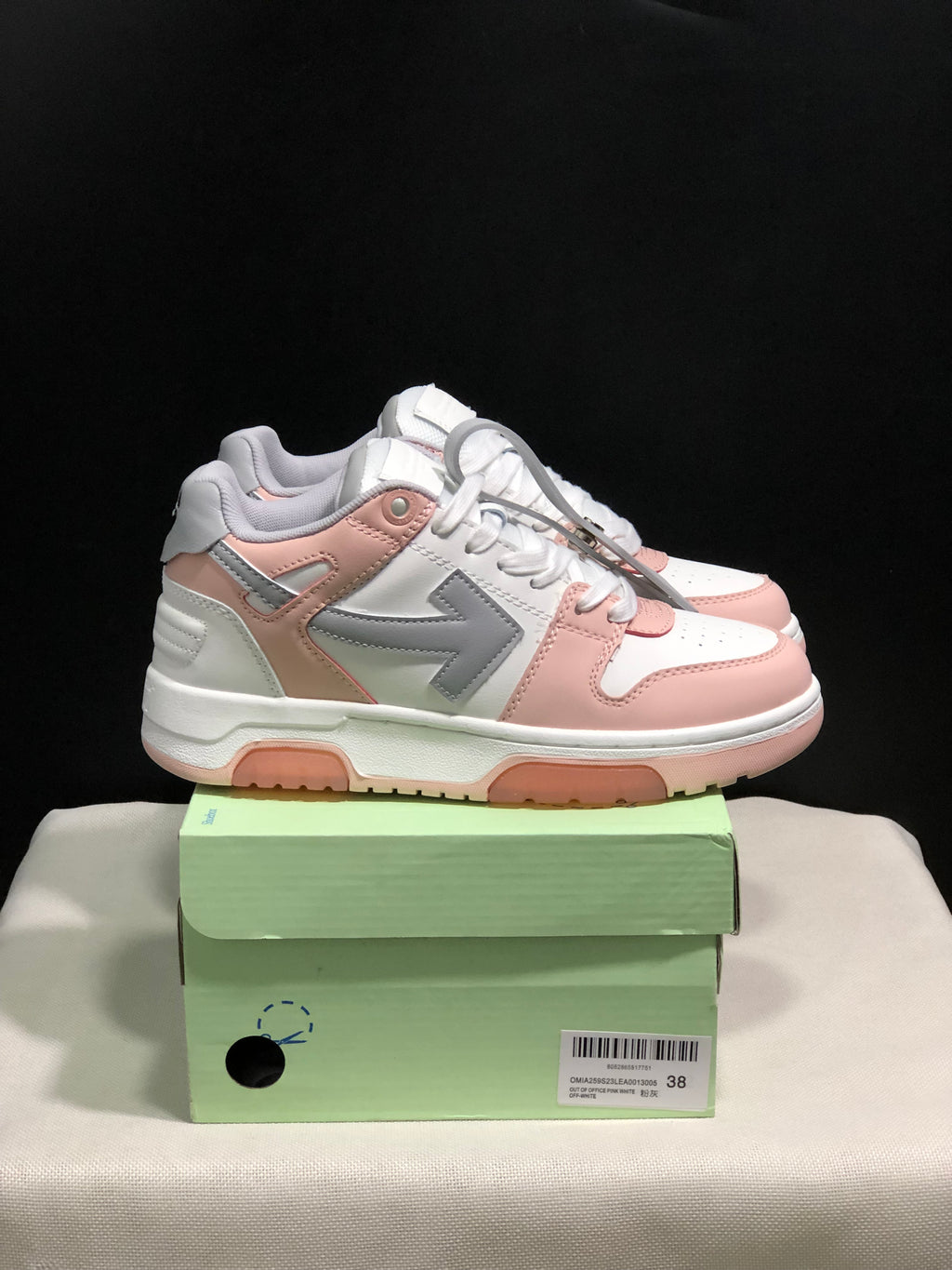 Side view of the white, pink and grey low-top sneakers showing the contrasting side panels and textured outsole.