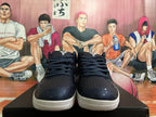 Front view of dark Nike basketball shoes with black laces and patterned toe overlays