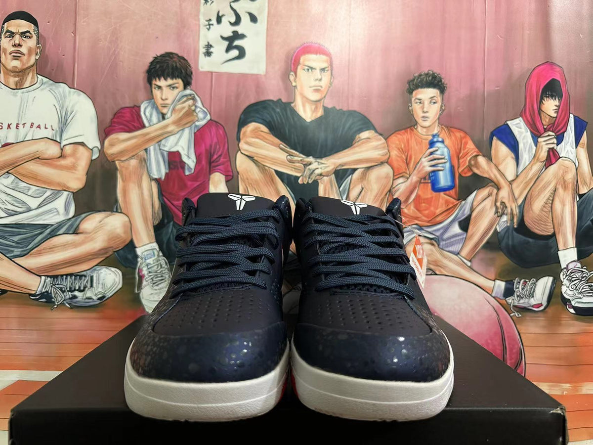Front view of dark Nike basketball shoes with black laces and patterned toe overlays