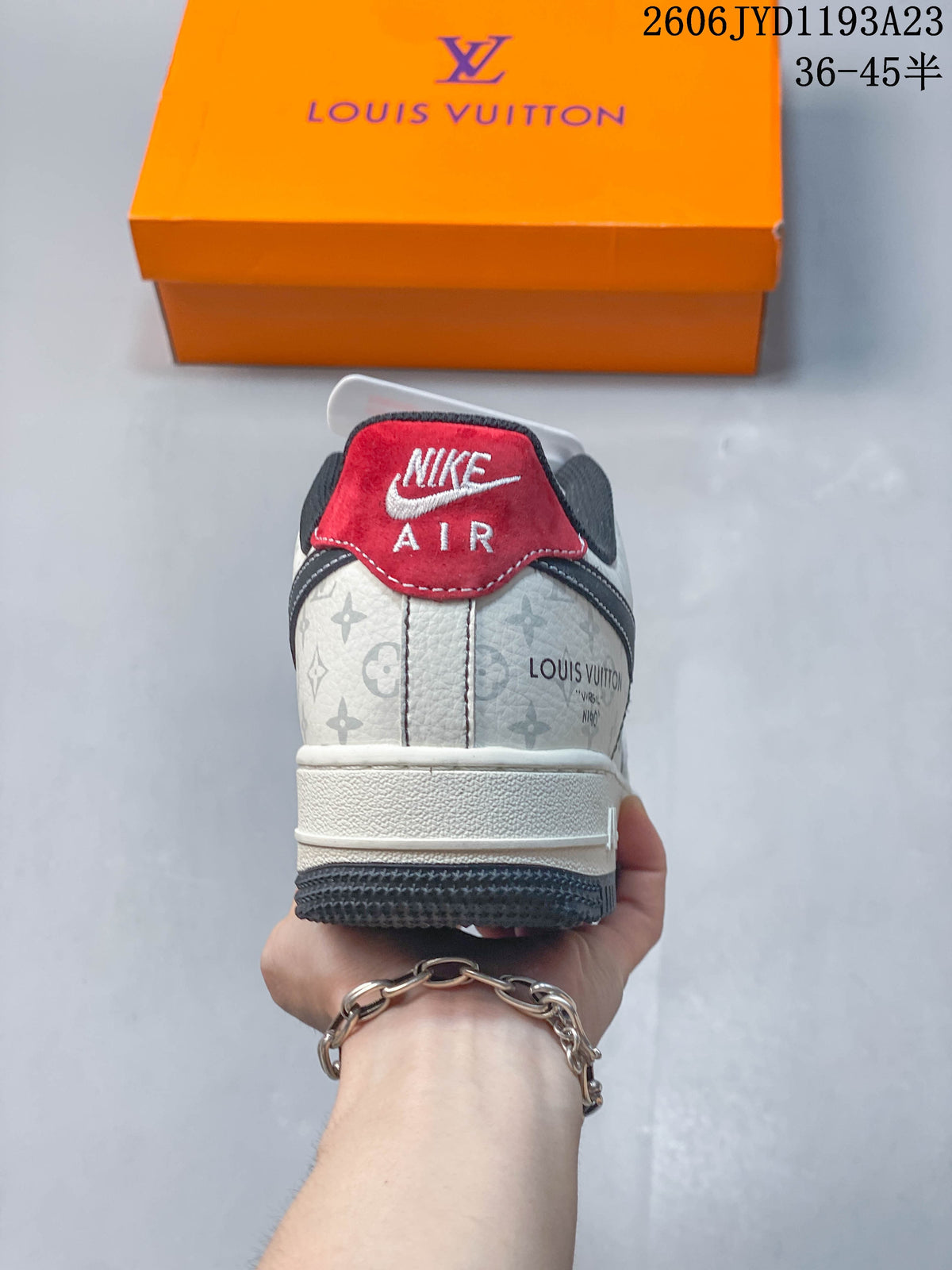Rear view of a sneaker with patterned panels and a red heel tab