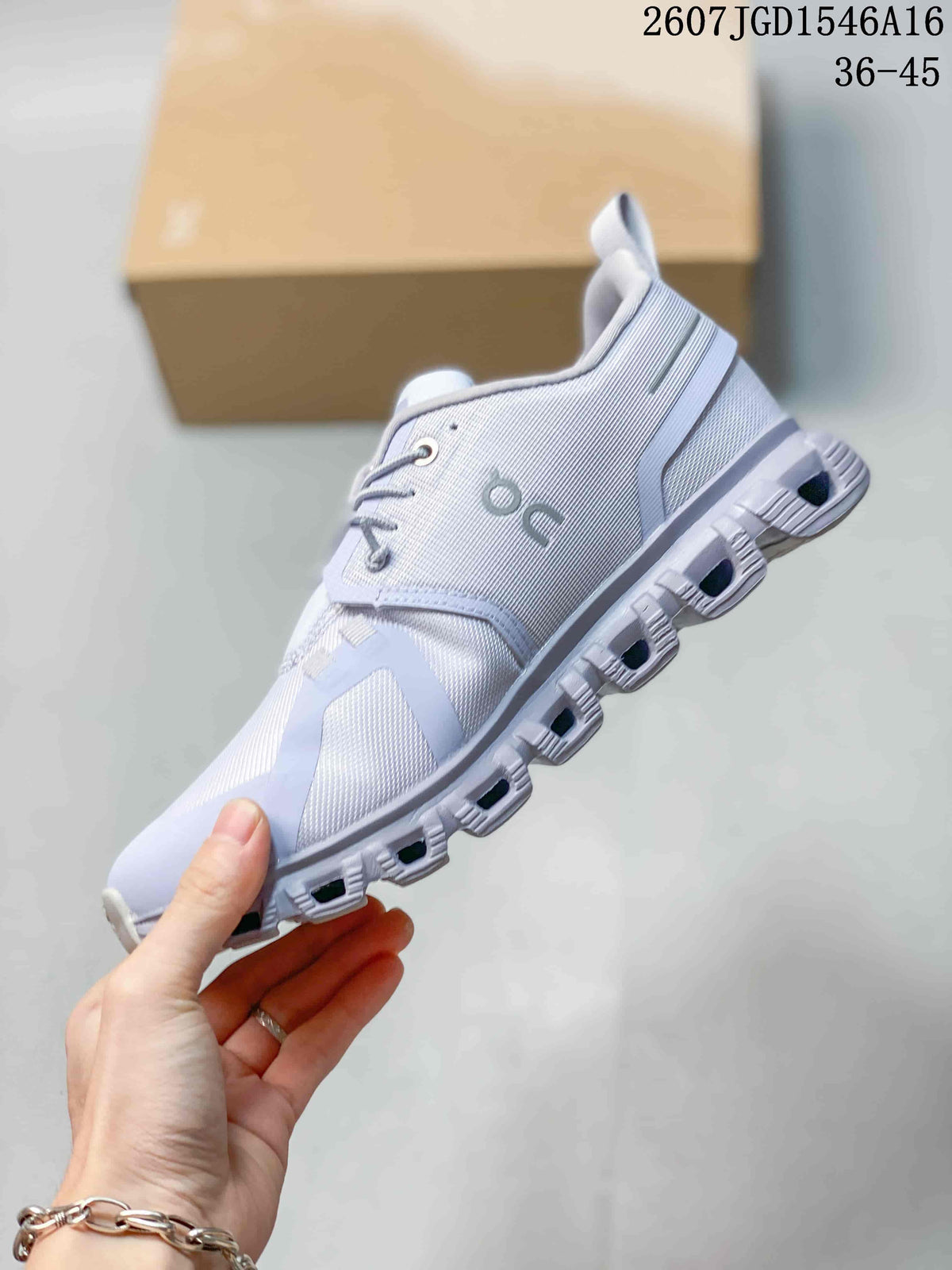 Side profile of the sneaker showing the mesh-like upper, lace system, side branding and segmented sole.