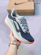 Angled side view showing the low-top shape, navy upper, mint-green side panel, white midsole and orange outsole.