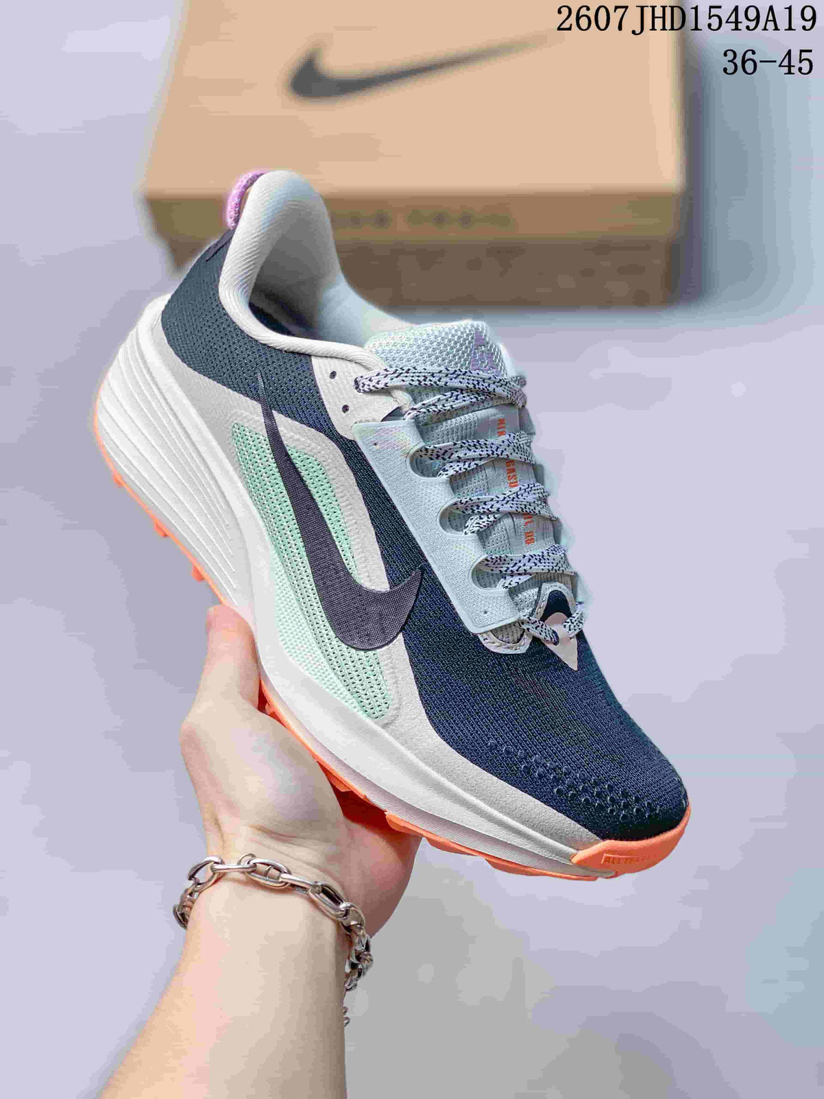 Angled side view showing the low-top shape, navy upper, mint-green side panel, white midsole and orange outsole.