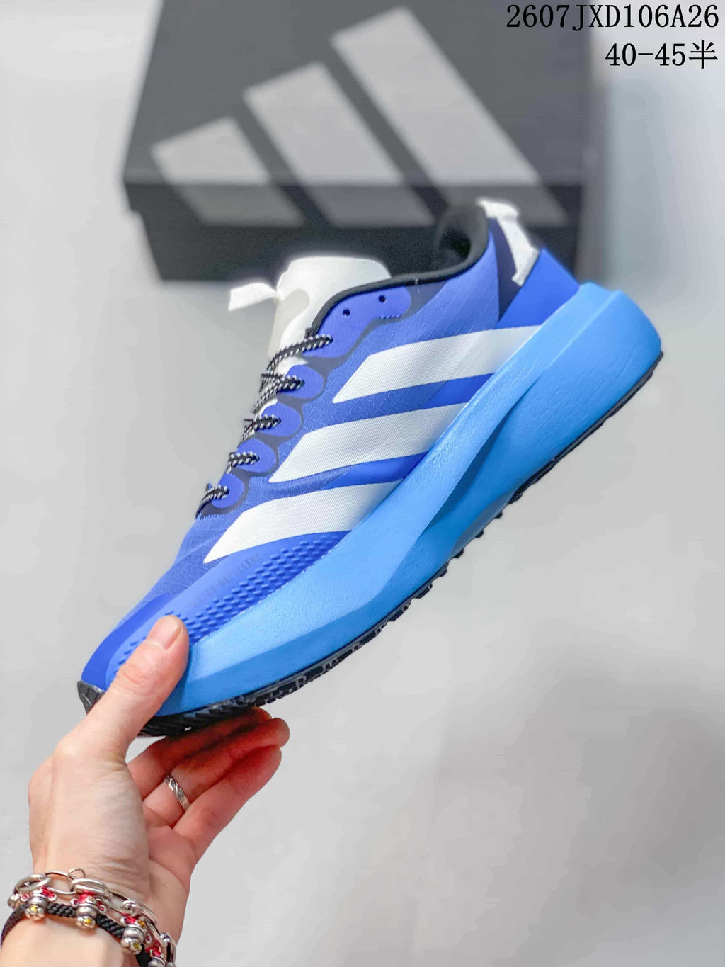 Side profile of the blue and white adidas sneaker showing layered side stripes, lace closure and raised blue midsole.