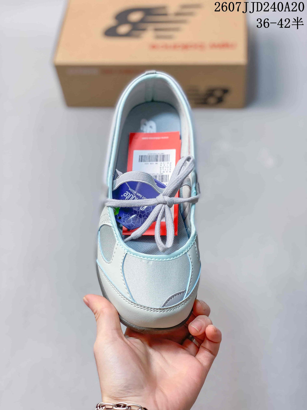 Top view showing the rounded toe, gray laces, light blue upper, and interior footbed.
