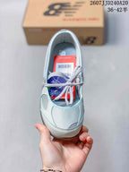 Top view showing the rounded toe, gray laces, light blue upper, and interior footbed.