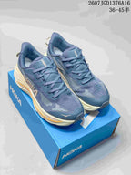 Pair of blue HOKA Challenger 8 shoes displayed on a blue shoebox, showing the cream midsoles and orange accents.