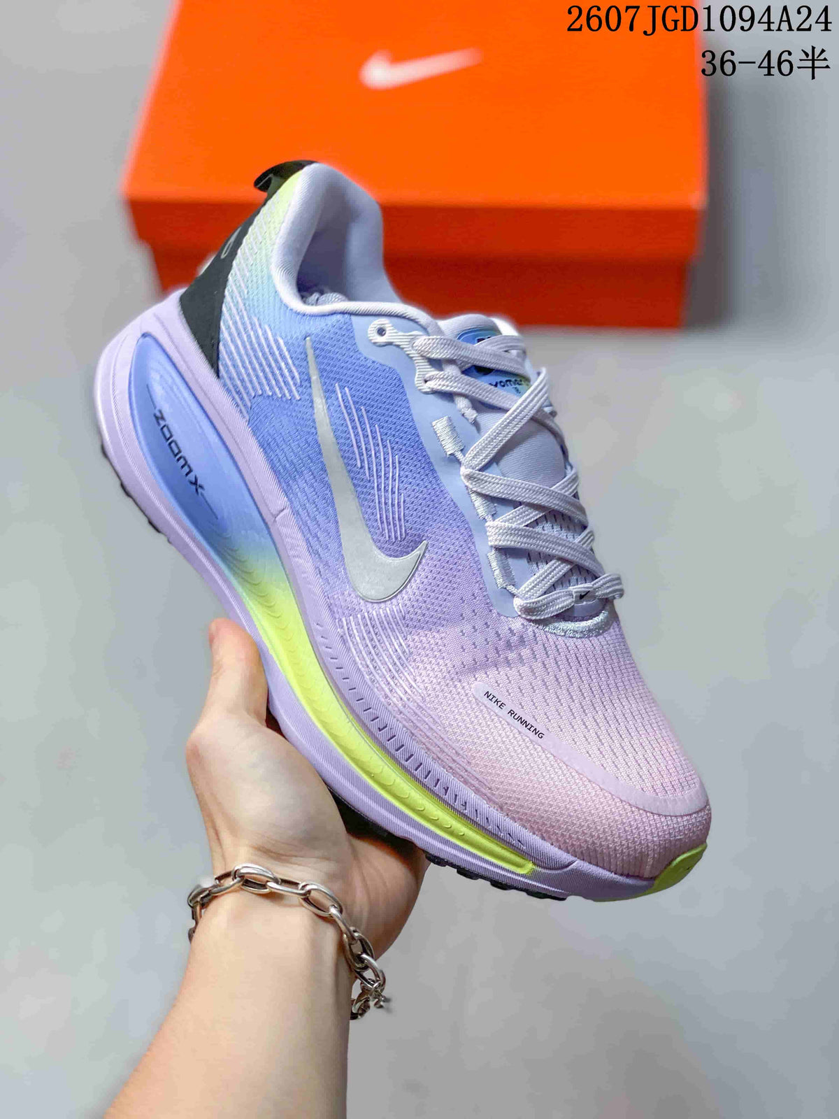 Angled side view showing the lavender textile upper, Nike Swoosh, black heel detail, and ZoomX marking.