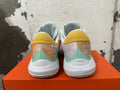 Rear view of pastel multicolor Nike basketball shoes with yellow heel panels and mint-green accents.