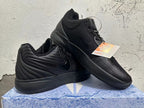 Two black shoes displayed together, showing their side and upper details
