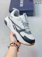 Angled side view of the Dior sneaker showing the rounded toe, lace-up design, layered upper, and chunky sole.
