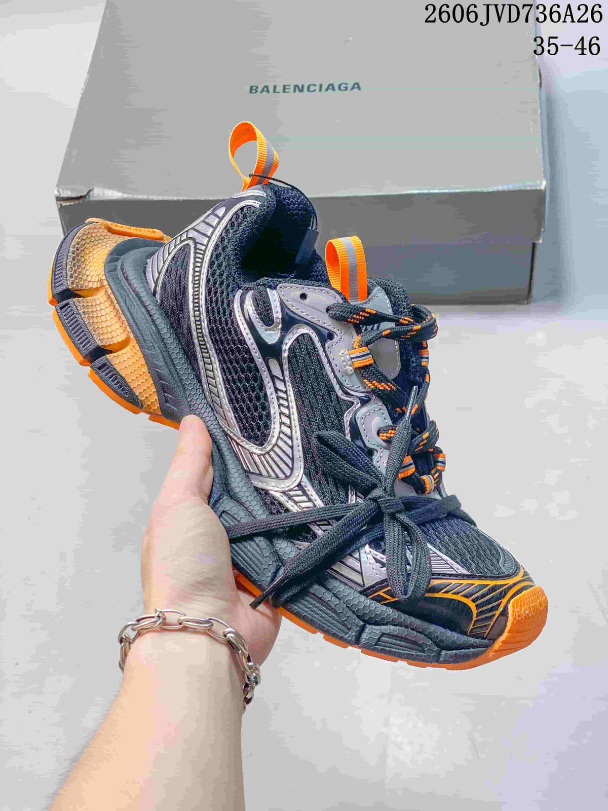 Dark gray Balenciaga 3XL-style sneaker with orange accents