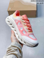Angled side view showing the white and pink upper, lace system, and sculpted outsole.