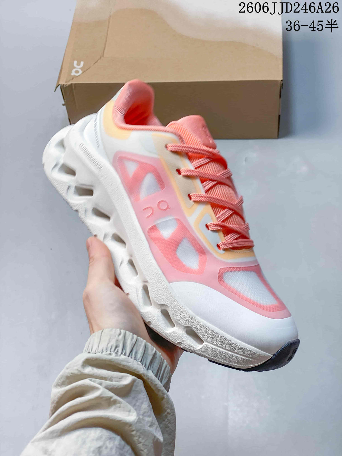 Angled side view showing the white and pink upper, lace system, and sculpted outsole.