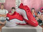 Pair of red and white basketball shoes shown from the side and above