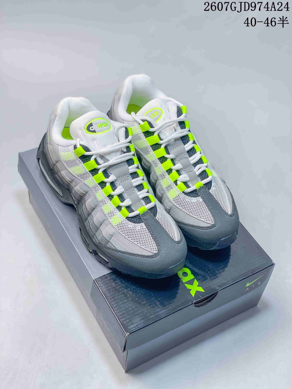 Pair of grey, black and neon green Nike Air Max 95-style sneakers displayed on a shoebox; image text shows JD974A24 and 40–46 sizing.