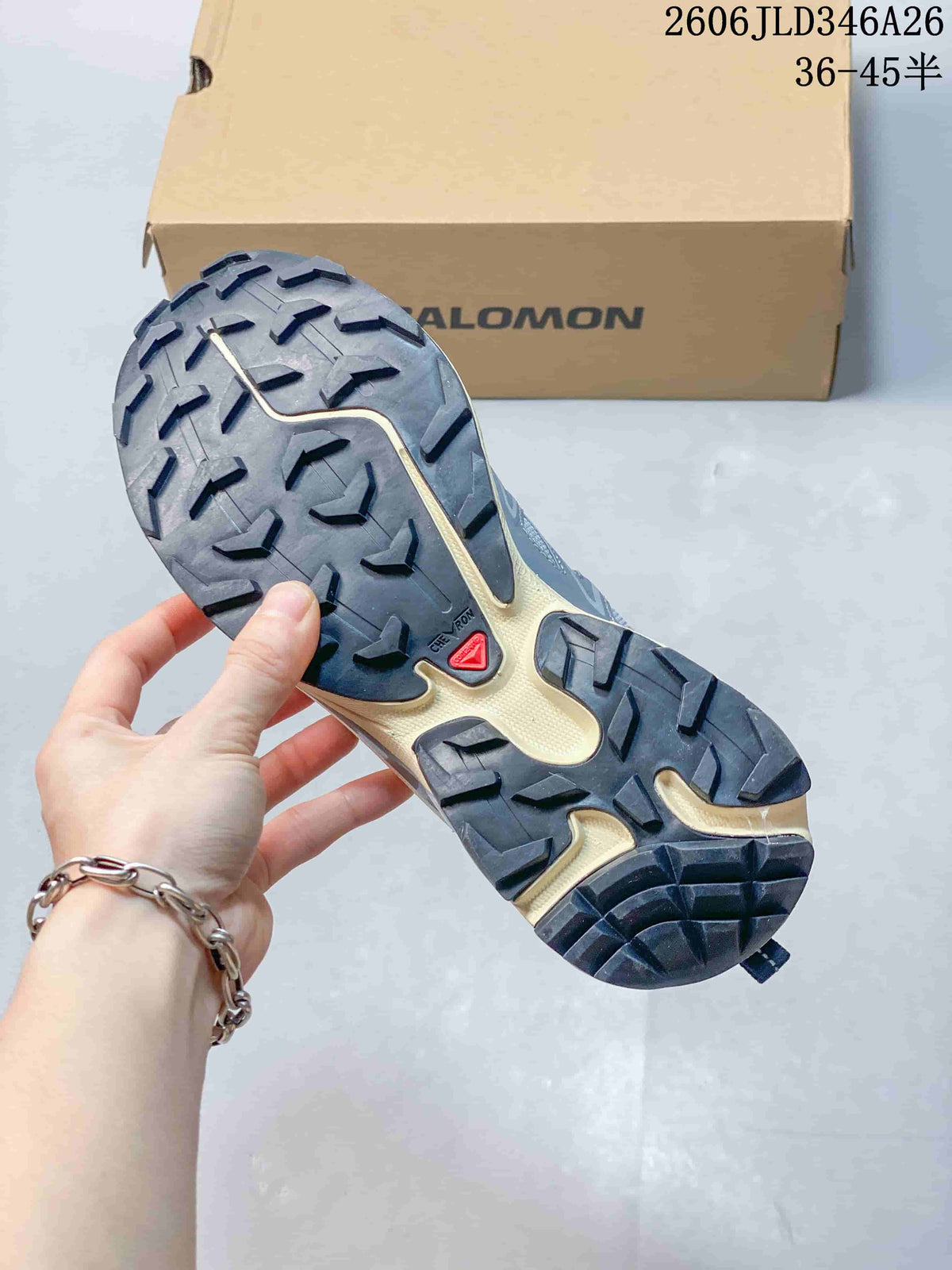Close-up of the lugged outsole on a Salomon XT-6 sneaker