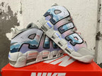 Pair of Nike Air More Uptempo sneakers showing the layered side design and chunky sole
