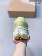 Rear view of the lime green and white sneaker showing the padded heel and outsole structure.