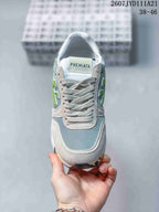 Front view of the sneaker showing gray laces, a padded tongue, and the Premiata branding.