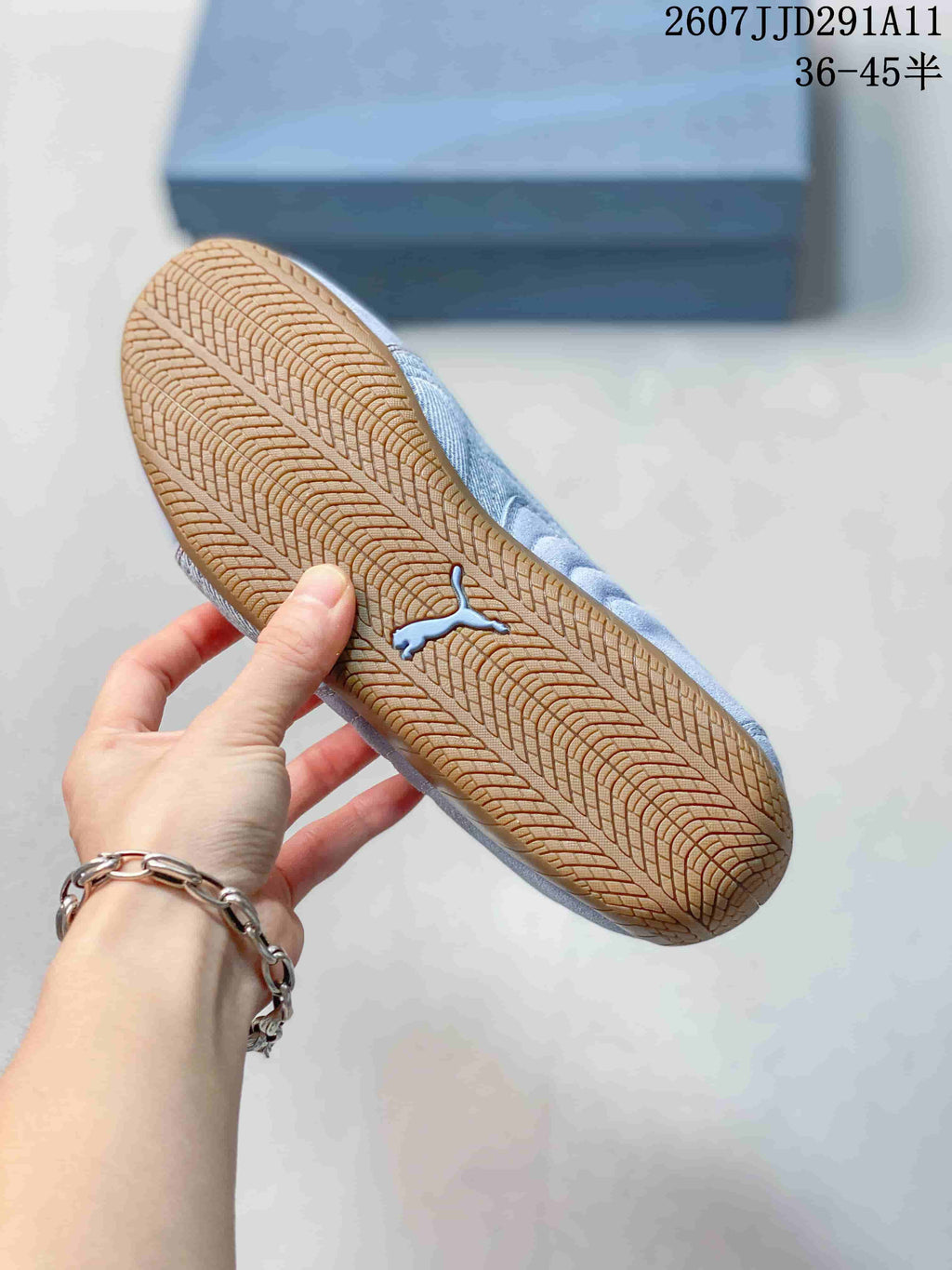 Close view of the gum-colored outsole showing its repeating tread pattern and PUMA cat logo.