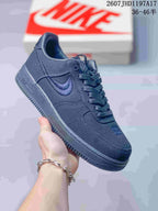 Side view of a black Nike Air Force 1 '07 x Stussy sneaker showing the embroidered Swoosh and low-top sole.