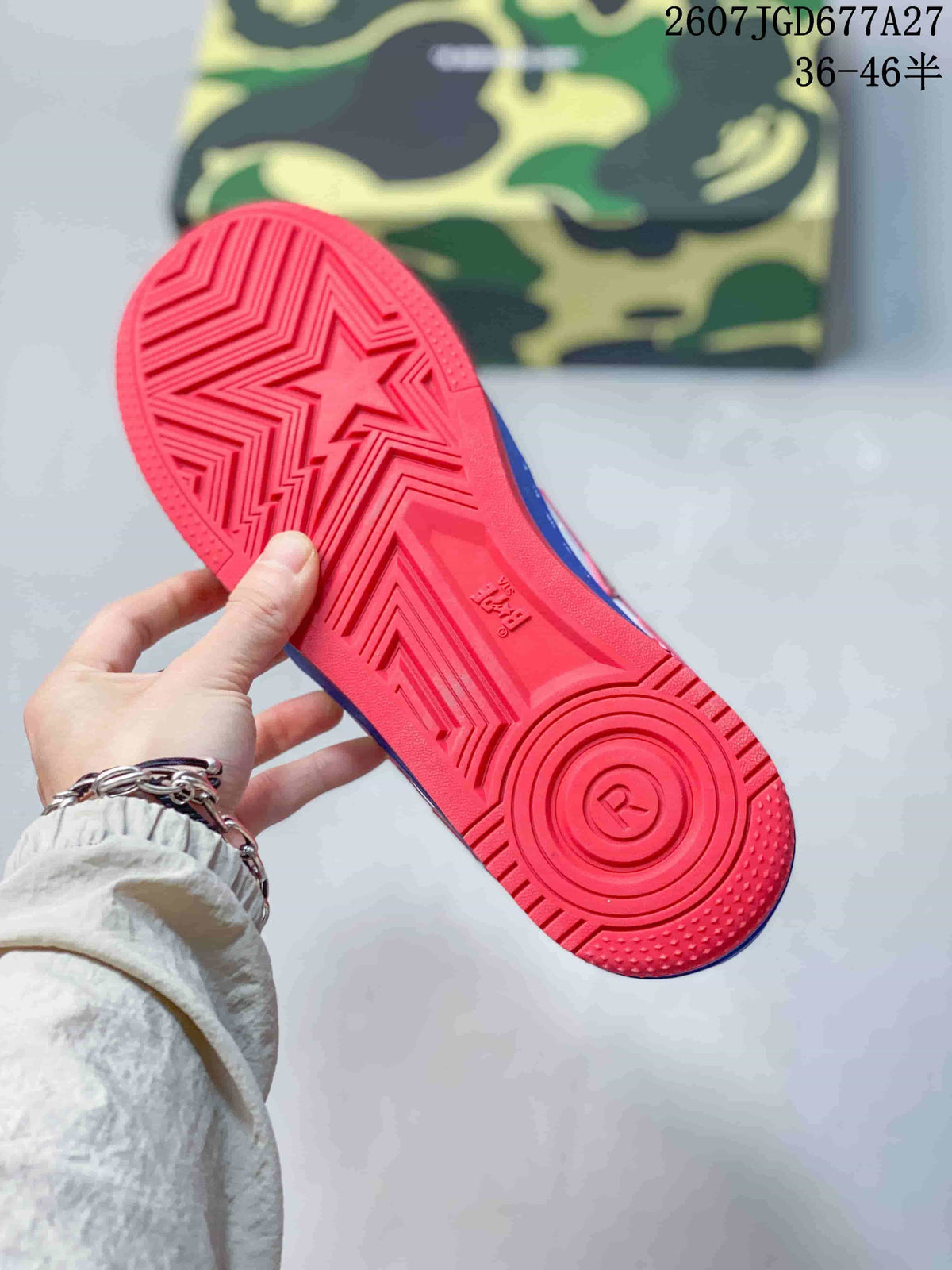 Red outsole of a blue low-top sneaker showing geometric tread lines and a central star motif.