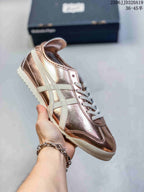 Metallic rose-gold low-top sneaker with pale side stripes