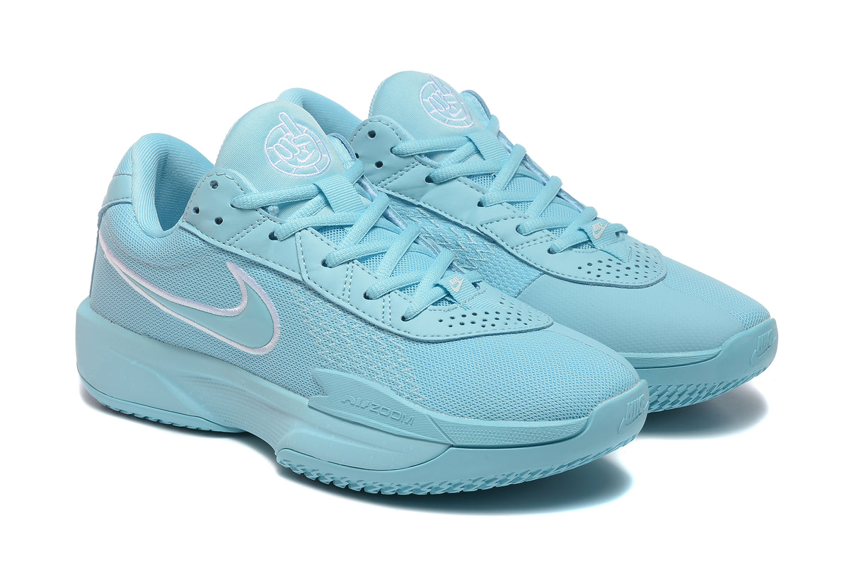 Pair of light-blue Nike G.T. Cut Academy shoes shown in a three-quarter view