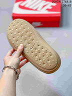 Close-up of the textured tan outsole showing circular traction elements and curved linear grooves.
