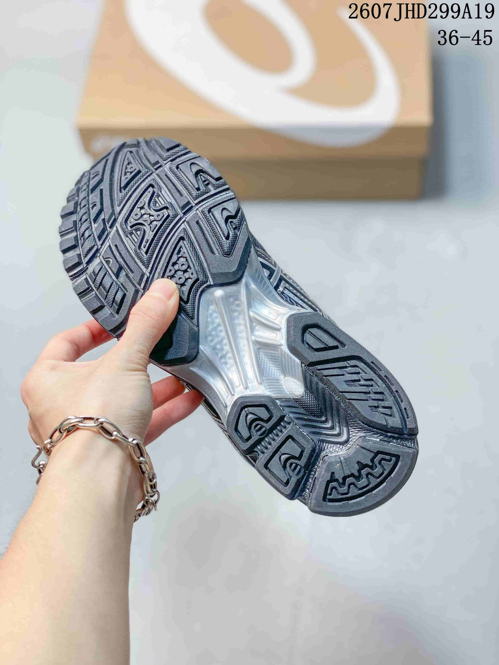 Close view of the sneaker outsole showing a patterned black and gray tread and a translucent midfoot section.