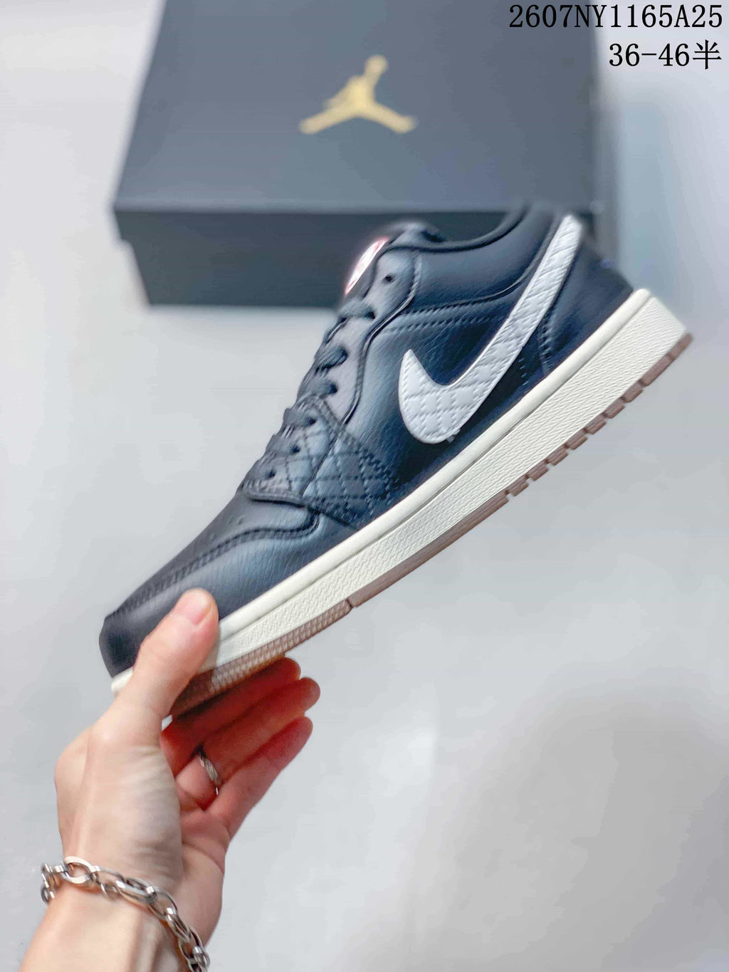 Side view showing the white Swoosh panel, black upper, light midsole, and gum-toned outsole