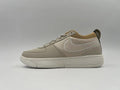 Side view of an off-white Nike low-top sneaker with a tonal Swoosh and textured side panel