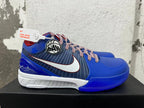 Side view of blue Nike Kobe basketball shoes with striped panels, a white Swoosh, and a basketball-themed emblem.