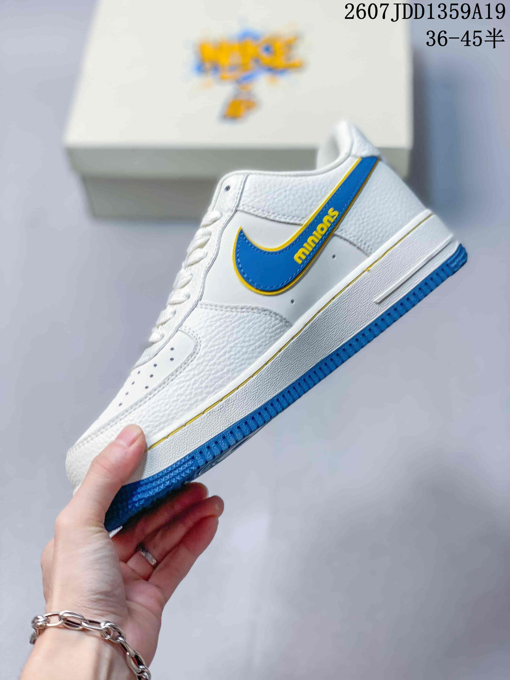 Side view highlighting the blue-and-yellow Swoosh-style detail, white upper and blue outsole.