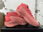 Pair of pink Adidas mid-top sneakers shown from the side, with a visible Adidas tag.
