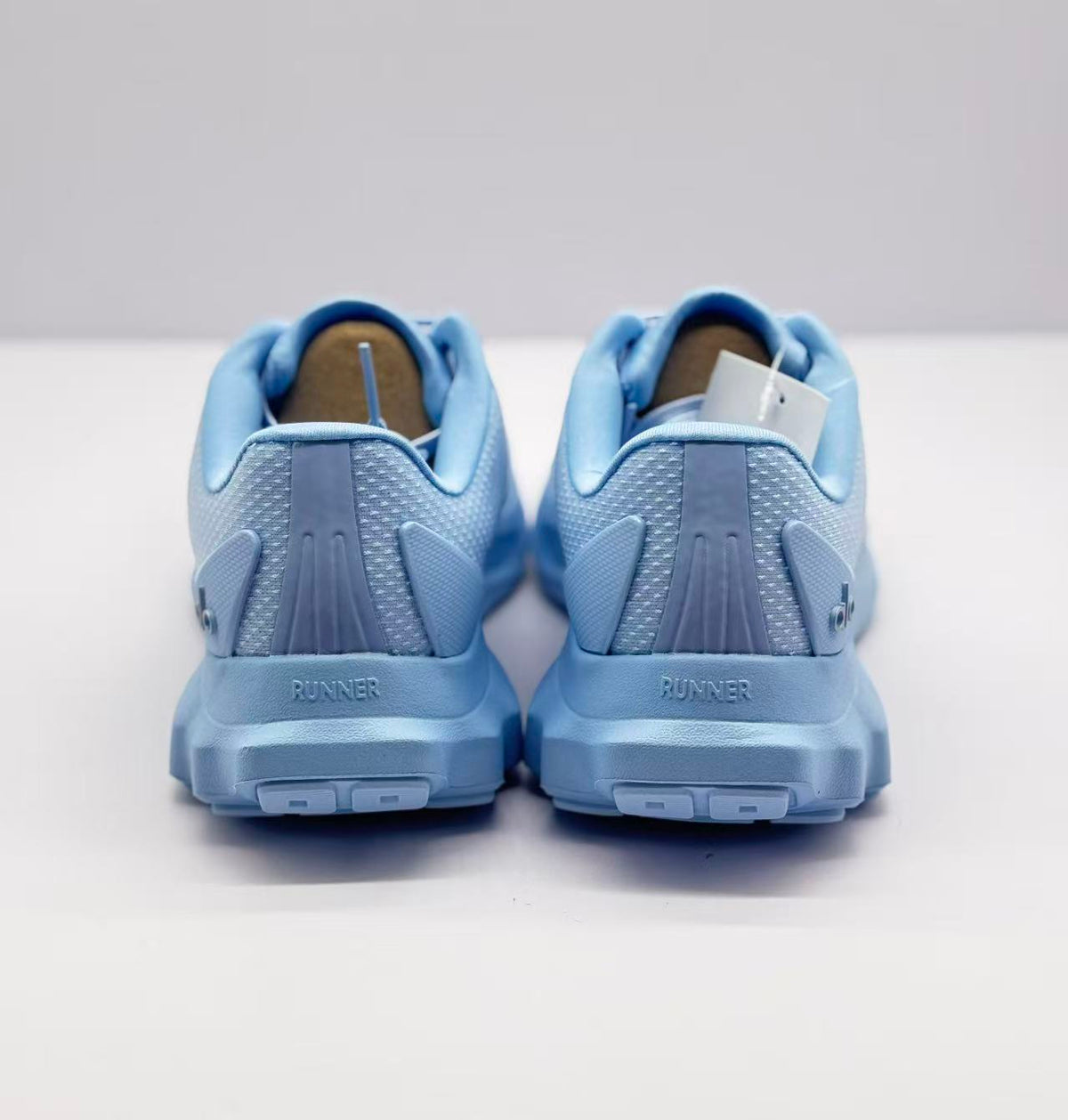Rear view of the sneakers showing RUNNER text on both heels and the outsole blocks.