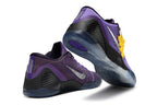Purple and black shoes shown from the heel and outsole.
