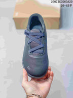 Top view of the dark navy sneaker showing the rounded toe, layered lace structure and padded opening.
