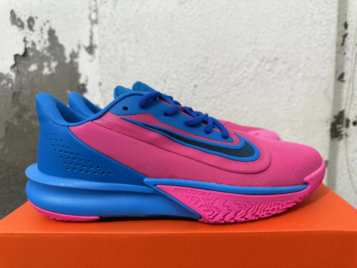 Side view of a pink and blue Nike Precision 7 shoe