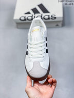 Top-down view of the sneaker showing white laces, a gray textured toe panel, and black side stripes.