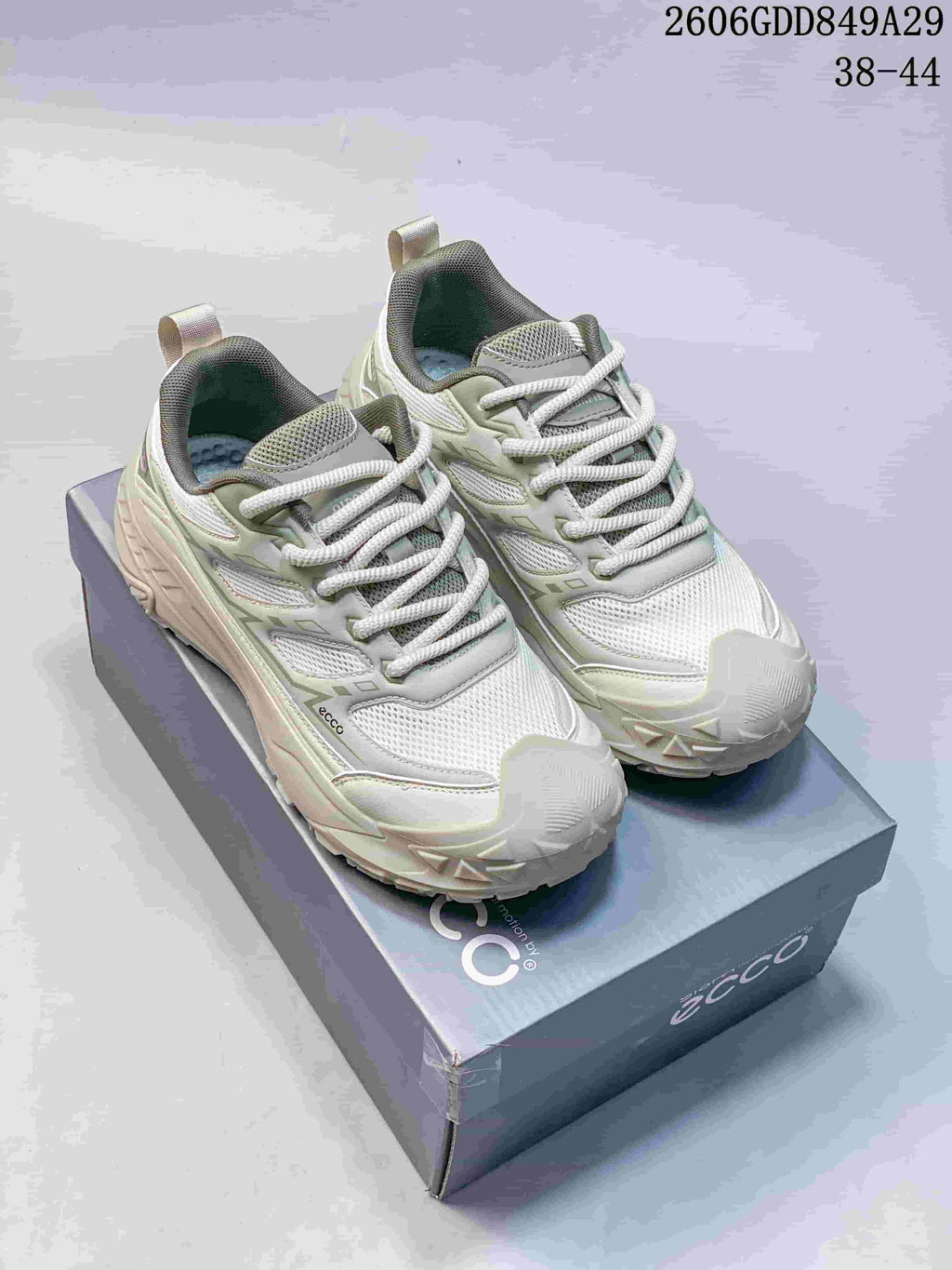 Pair of light gray ECCO mesh sneakers with muted green accents, photographed on a branded box