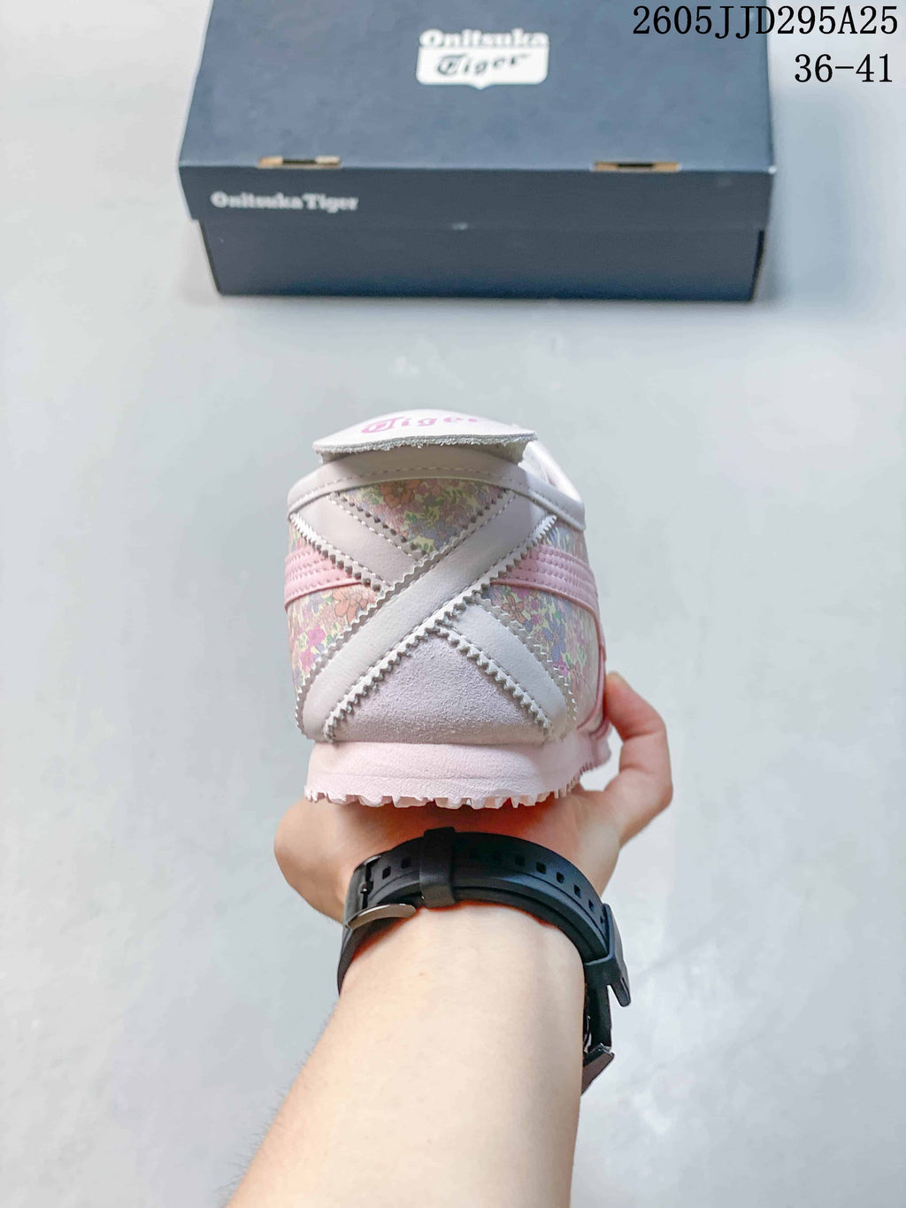 Rear view showing the pink and white heel detailing and textured outsole.
