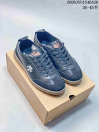 Pair of dark navy low-top sneakers with contrasting panels and side emblems