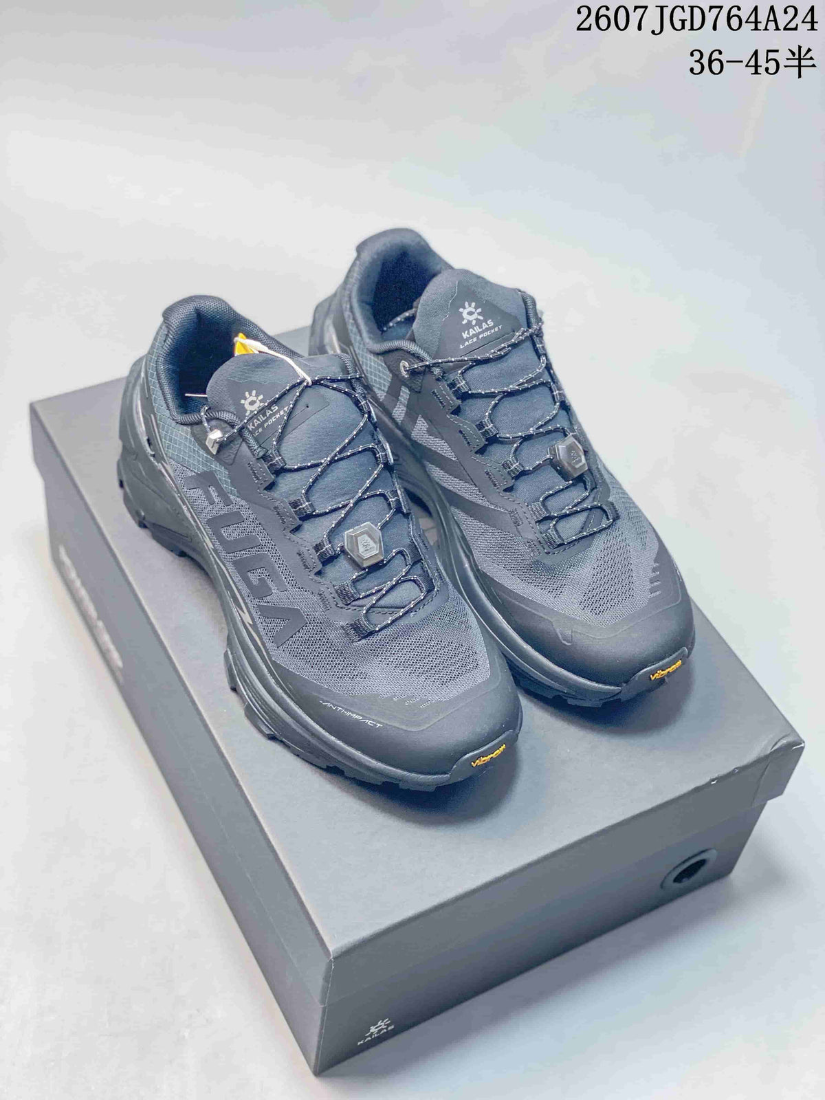 Pair of dark gray and black Kailas FUGA EX3 trail running shoes displayed on a shoebox.